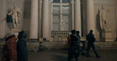 People passing by artist selling works in the street, Russia video