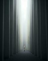a person standing in a dark tunnel with pillars generative ai photo