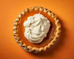 a pumpkin pie with whipped cream on top of an orange background generative ai photo