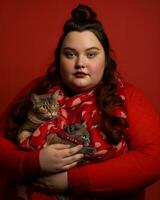 a woman in a red sweater holding two cats generative ai photo