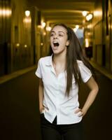 a woman in a white shirt and black pants standing in an empty hallway generative ai photo