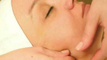 Massage treatment of womans face at beauty spa video
