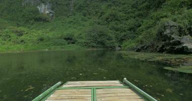 In Trang an bai in Hanoi, Vietnam riding from first-person on boat on river with scenic views video