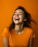 portrait of smiling young woman laughing on orange background stock photo generative ai