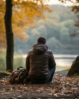 a man sitting on the ground with his back to the camera generative ai photo