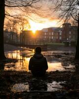 a person sitting on the ground in front of a body of water generative ai photo