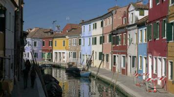 Scene with canal and colourful houses alongside in Burano island, Italy video