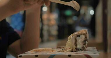 Boy eating ice cream dessert in shipping mall food court video