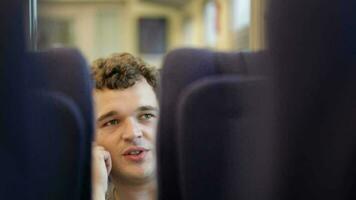 Man talking on the phone in train video