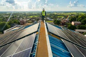 Asian engineer checking equipment in solar power plant on roof. clean energy photo