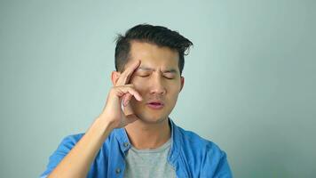 Asian man in thinking, making decision, standing hesitant over white background. photo