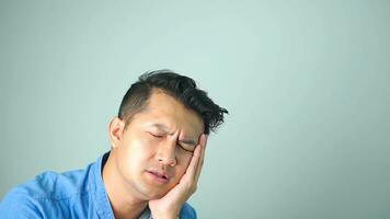 Young asian man action feeling very bad pain from toothache on white background. photo