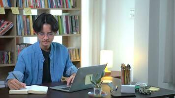 Young asian is working on laptop in the home. photo