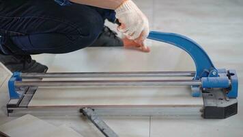 Asia men worker builder cutting tiles using a tile cutting machine at site photo