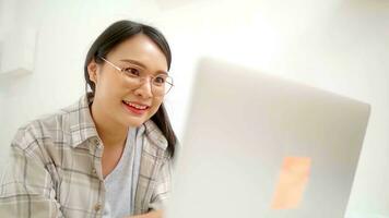Asian freelance business woman using laptop online business  in bed at home. photo
