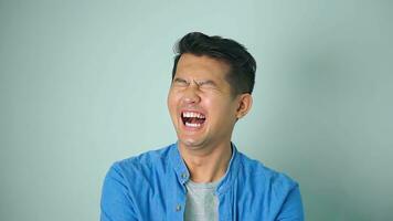 Asian man happy laughing standing on white background. photo