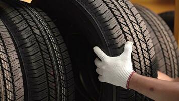 A car maintenance worker checking the quality of the tires. Transport. photo