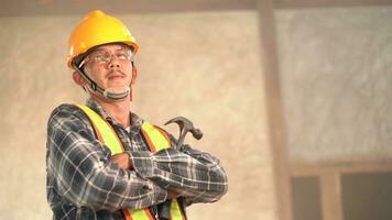 Carpenter young asia standing crossed arms smile in furniture factory. Happy young attractive carpenter wearing plaid shirt standing with crossed arms smiling and looking to camera. photo