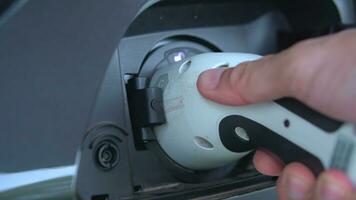 Open - close lid charging, Close up hand man  inserting plug into charging electric car. photo