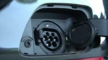 Open - close lid charging, Close up hand man  inserting plug into charging electric car. photo