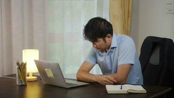 Asian man tired from working at home. photo