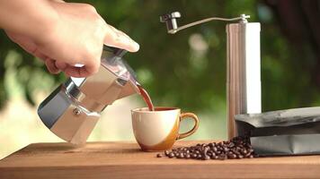 Moka pot and pouring coffee. photo