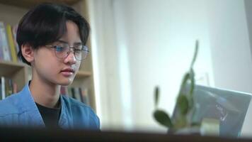 Young asian is working on laptop in the home. photo
