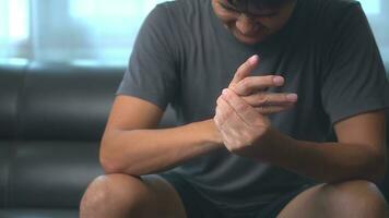 Close up hand of asian man he massages and has finger pain, locked finger from using laptop for long period of time. photo