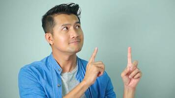 Asian man happy smile standing hand pointing to empty space on white background. photo