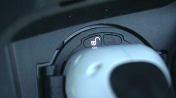 Open - close lid charging, Close up hand man  inserting plug into charging electric car. photo