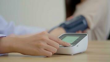 Focus on the pressure gauge Asian female doctor measuring heart rate and blood pressure. photo