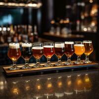 Flight of beer for tasting on a bar counter with a blurred background. photo