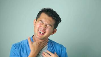 Sick asian man with sore throat on white background. photo