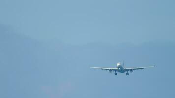 Long shot, passenger plane approaching to land. Airliner is flying, front view video