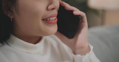 Asian woman talking with friends or family on a smartphone photo