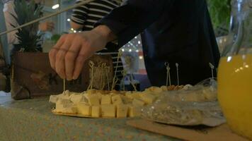 Man taking cheese from buffet table video