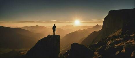 Young man standing on top of cliff in summer mountains at sunset and enjoying view of nature, generative ai photo