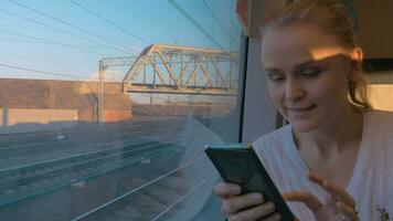 In Saint-Petersburg, Russia in train rides young girl and looking out the window video