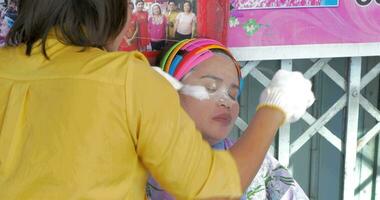 Service of eyebrow pluckering in the street Bangkok, Thailand video