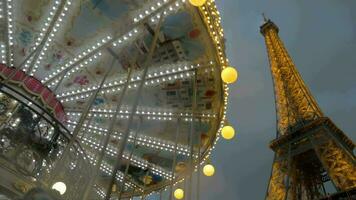 Illuminated Eiffel Tower and vintage carousel video