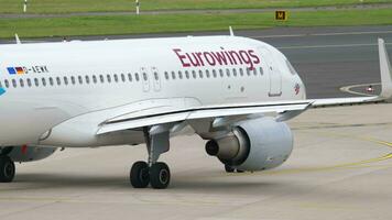 DUSSELDORF, GERMANY JULY 23, 2017 - Passenger plane Eurowings taxiing along the taxiway at Dusseldorf Airport DUS. Airplane on the runway. Eurowings German low cost airline video