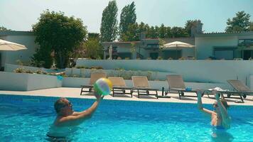 Man and Woman Playing Ball in Home Pool video