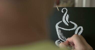 Man drawing coffee cup with chalk video