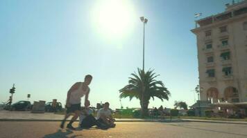 A teenager doing a lot of cart-wheels and jumps in the air outside video