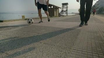 Two Men Dribbling Soccer Ball on the Footwalk video