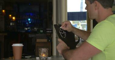 Man in cafe drawing coffee list with chalk video