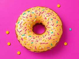 Yellow donut with sprinkles isolated on purple background photo