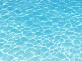 Swimming pool surface with light reflection and water ripple patterns photo