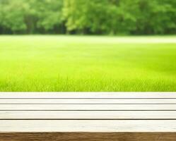 Empty wooden table with blurred meadows and farms background photo