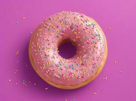 Pink donut closeup on purple background photo